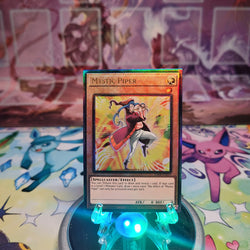 A Prismatic Ultimate Rare "Mystic Piper" card from the Yugioh Set: Quarter Century Stampede (RA04).