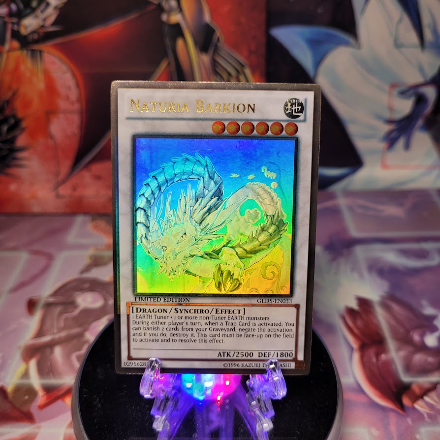 A Gold Ghost Rare "Naturia Barkion" card from the Yugioh Set: Gold Series: Haunted Mine.