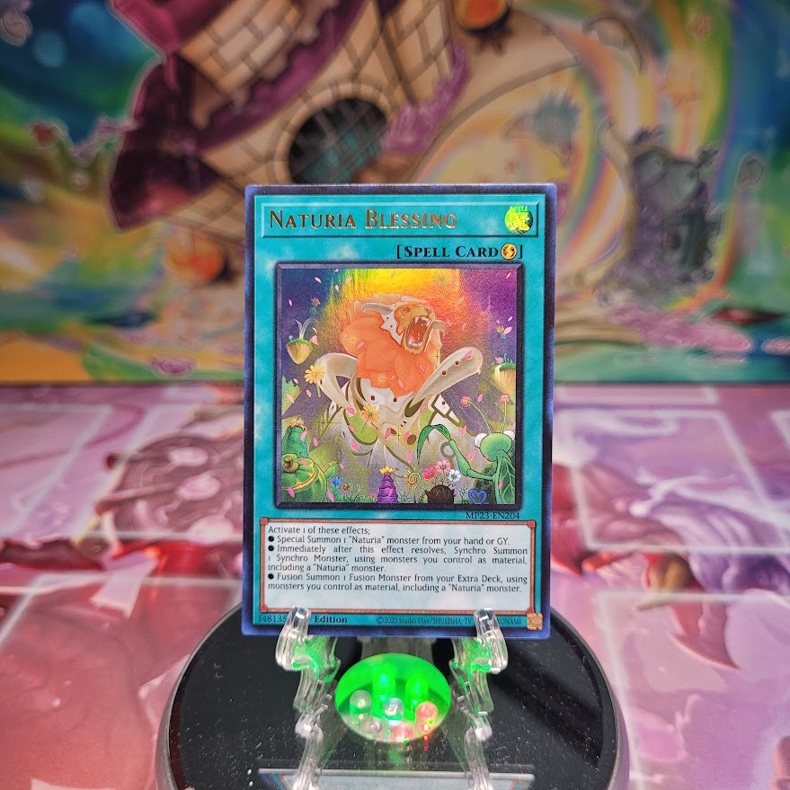 An Ultra Rare "Naturia Blessing" card from the Yugioh Dueling Heroes Mega-Tin Mega Pack.