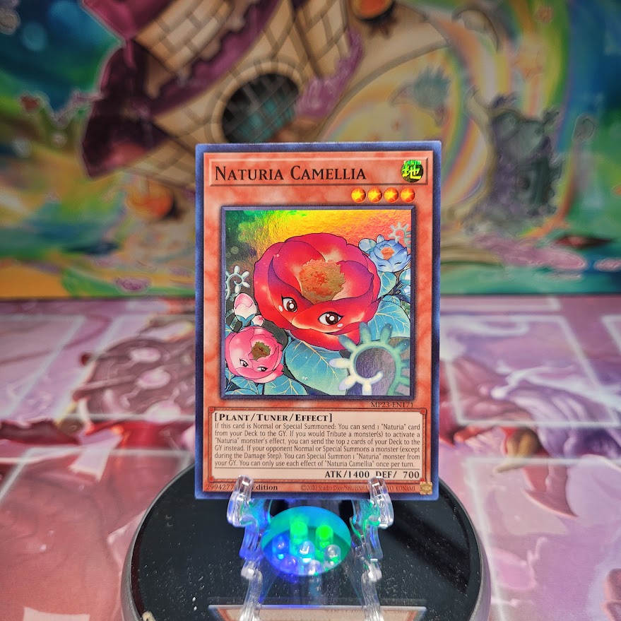 A Super Rare "Naturia Camellia" card from the Yugioh Dueling Heroes Mega-Tin Mega Pack.