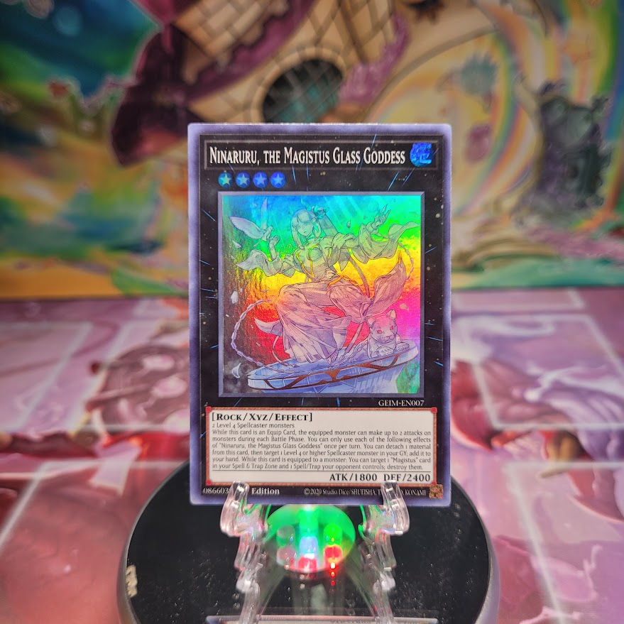 A 1st edition Super Rare "Ninaruru, the Magistus Glass Goddess" card from the Yugioh Set: Genesis Impact.