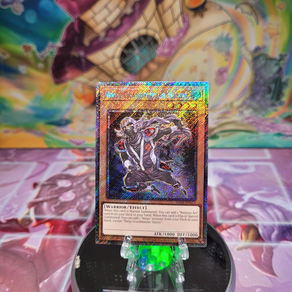 A Platinum Secret Rare "Ninja Grandmaster Hanzo" card from the Yugioh Set: Quarter Century Stampede (RA04).