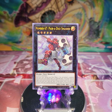 A Secret Rare "Number 67: Pair-A-Dice Smasher" card from the Yugioh Set: Battles of Legend: Relentless Revenge (BLRR). 