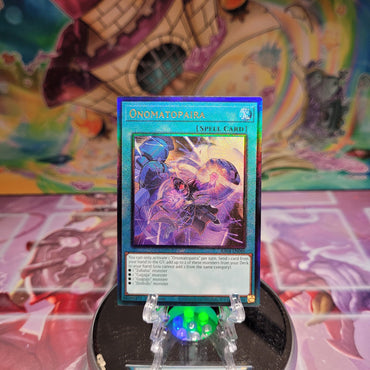 A Prismatic Ultimate Rare "Onomatopaira" card from the Yugioh Set: Quarter Century Stampede (RA04).