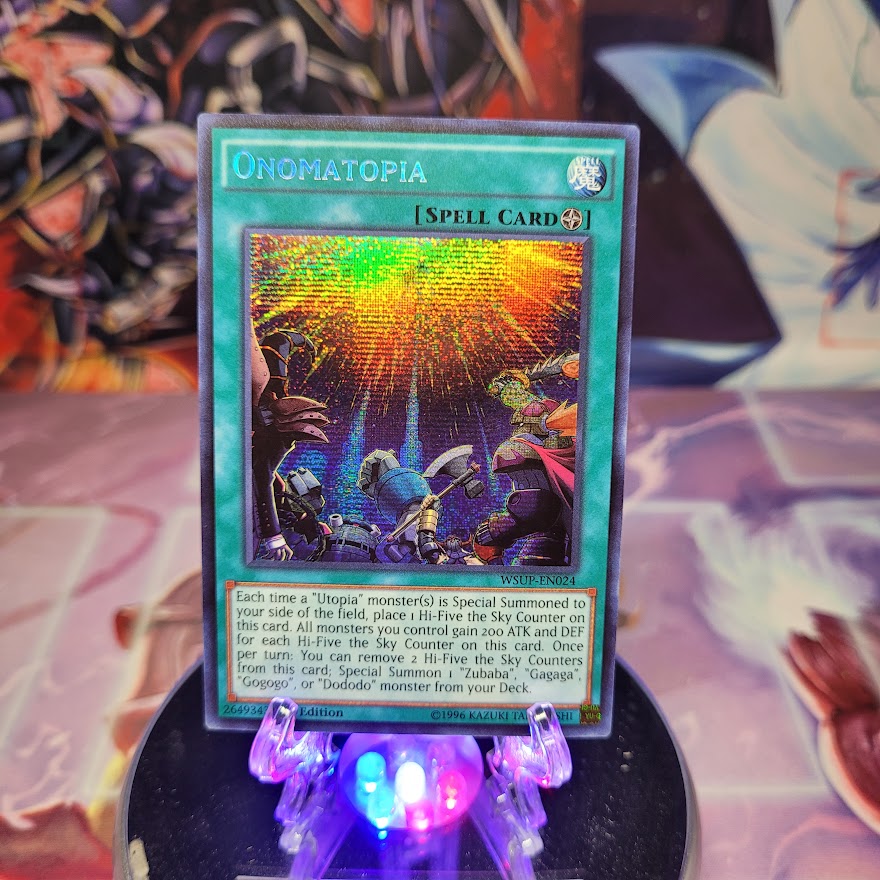 A Prismatic Secret Rare "Onomatopia" card from the Yugioh Set: World Superstars.