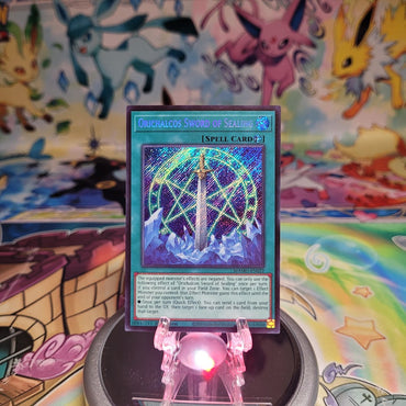 A Secret Rare "Orichalcos Sword of Sealing" card from the Yugioh Set: Magnificent Monsters (MAMO).