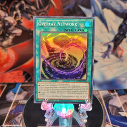 A Super Rare "Overlay Network" card from the Yugioh Set: Maze of Memories.