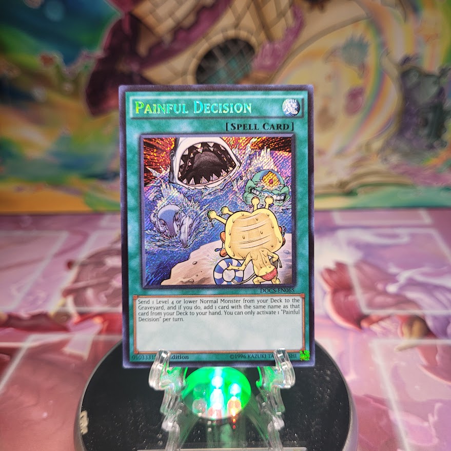 A Secret Rare "Painful Decision" card from the Yugioh Set: Dimension of Chaos.