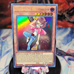  An Ultra Rare "Performapal Miss Director" card from the Yugioh Set: Ghosts From the Past: The 2nd Haunting (GFP2).