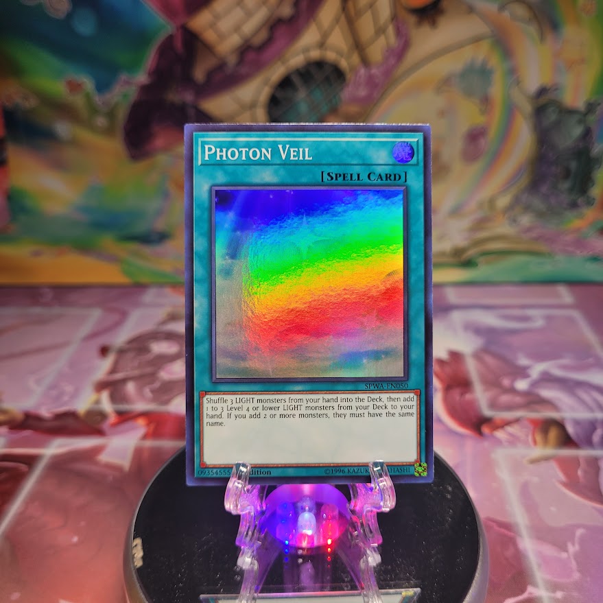 A 1st edition Super Rare "Photon Veil" card from the Yugioh Set: Spirit Warriors.