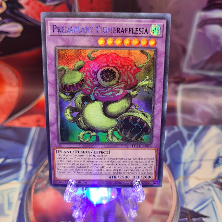 An Ultra Rare Blue "Predaplant Chimerafflesia" card from the Yugioh Set: Legendary Duelists: Season 3.