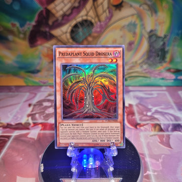 A Super Rare "Predaplant Squid Drosera" card from the Yugioh Set: Fusion Enforcers. 