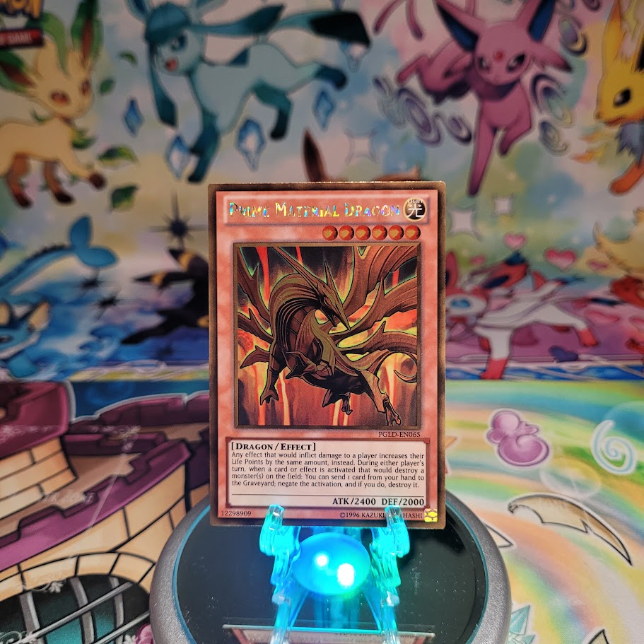 A Gold Rare "Prime Material Dragon" card from the Yugioh Set: Premium Gold (PGLD).