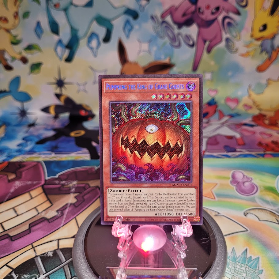A Secret Rare "Pumpking the King of Grave Ghosts" card from the Yugioh Set: Maze of Muertos (MZMU).