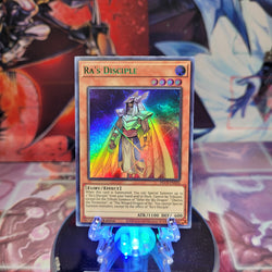 An Ultra Rare Green "Ra's Disciple" card from the Yugioh Set: Dragons of Legend: The Complete Series (DLCS).