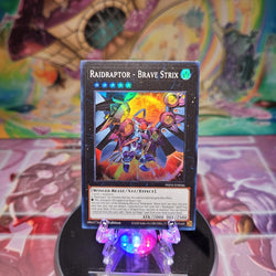 A Super Rare "Raidraptor - Brave Strix" card from the Yugioh Set: Phantom Nightmare.