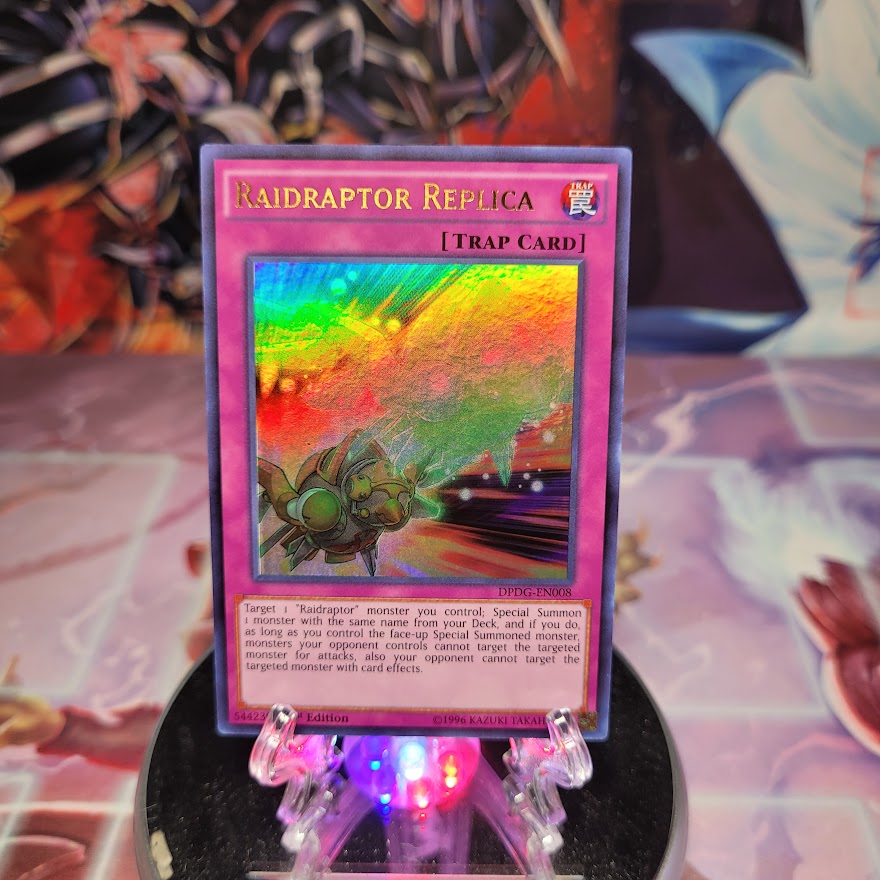 An Ultra Rare "Raidraptor Replica" card from the Yugioh Set: Duelist Pack: Dimensional Guardians (DPDG).