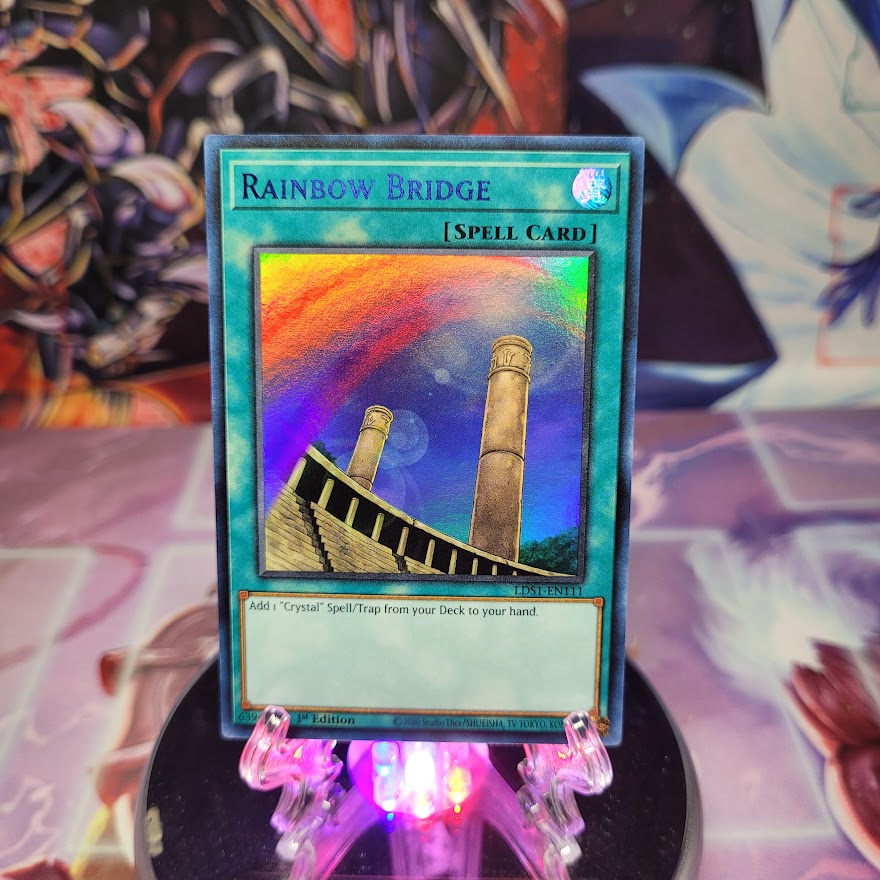 An Ultra Rare Blue "Rainbow Bridge" card from the Yugioh Set: Legendary Duelists: Season 1 (LDS1).