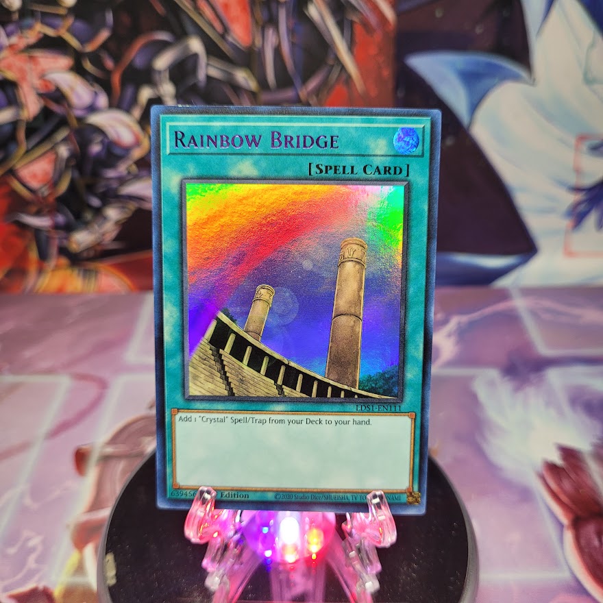 An Ultra Rare Purple "Rainbow Bridge" card from the Yugioh Set: Legendary Duelists: Season 1 (LDS1).