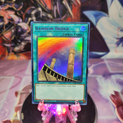 An Ultra Rare Purple "Rainbow Bridge" card from the Yugioh Set: Legendary Duelists: Season 1 (LDS1).