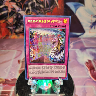 A Prismatic Secret Rare "Rainbow Bridge of Salvation" card from the Yugioh 2022 Tin of the Pharaoh's Gods.