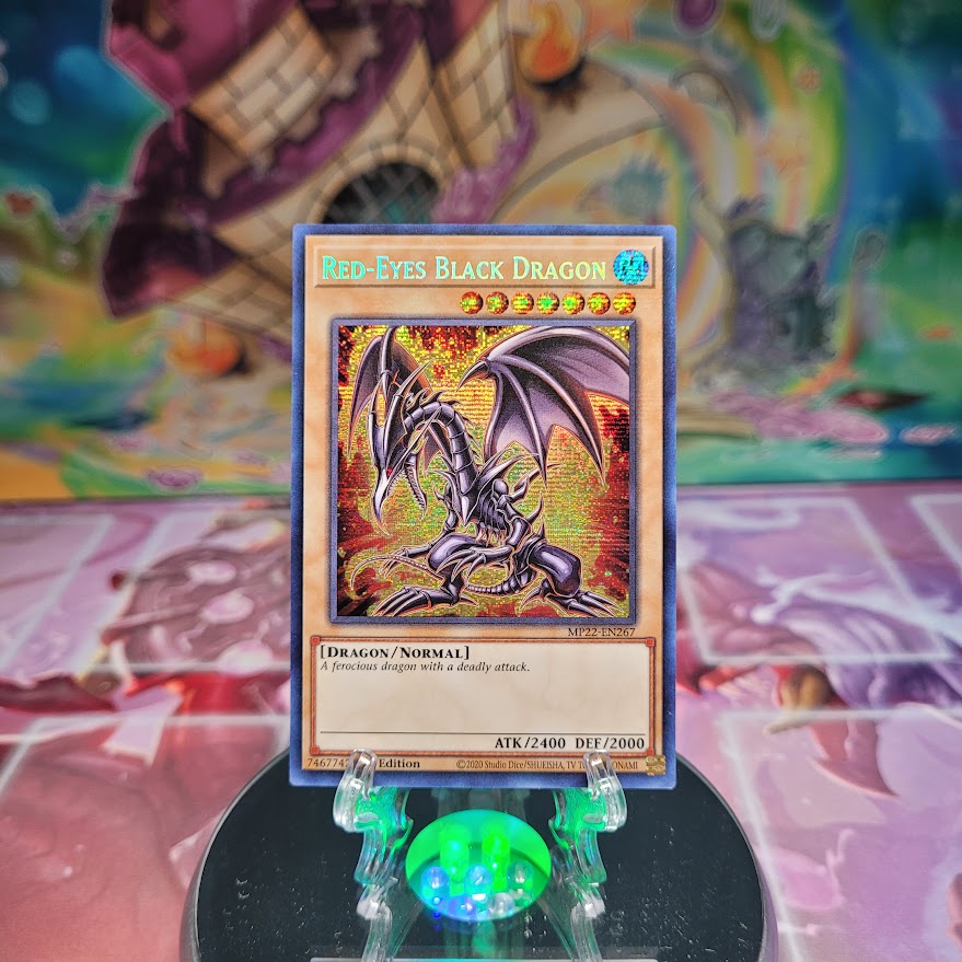 A Prismatic Secret Rare "Red-Eyes Black Dragon" card from the Yugioh 2022 Tin of the Pharaoh's Gods set.