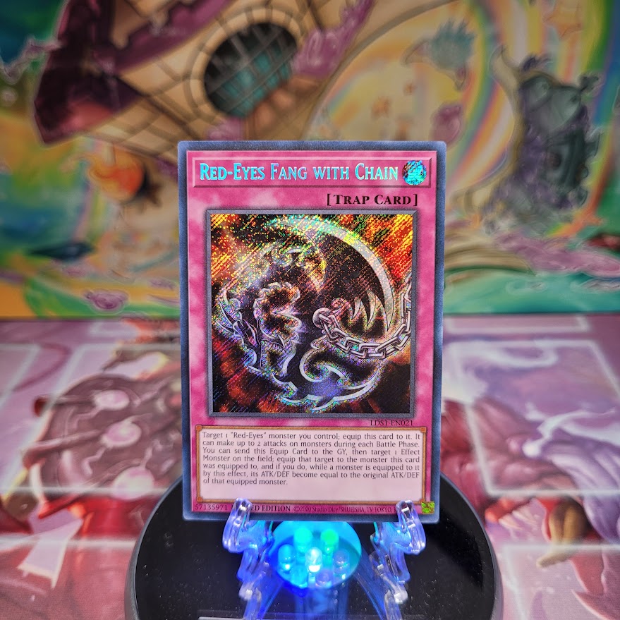 A Secret Rare "Red-Eyes Fang With Chain" card from the Yugioh Set: Legendary Duelist: Season 1.