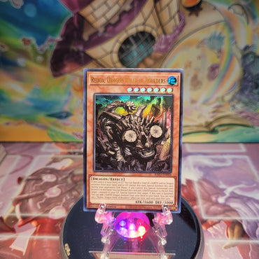 An Ultra Rare "Redox, Dragon Ruler of Boulders" card from the Yugioh Set: Quarter Century Bonanza (RA03).