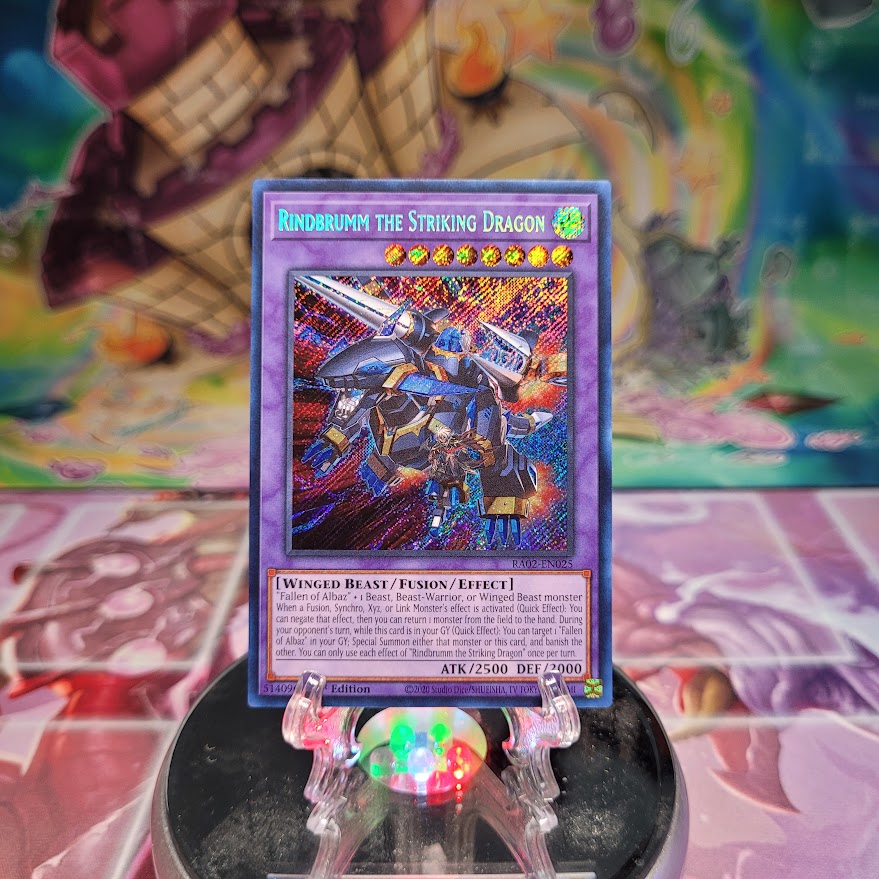 A Secret Rare "Rindbrumm the Striking Dragon" card from the Yugioh Set: Rarity Collection 2 (RA02).