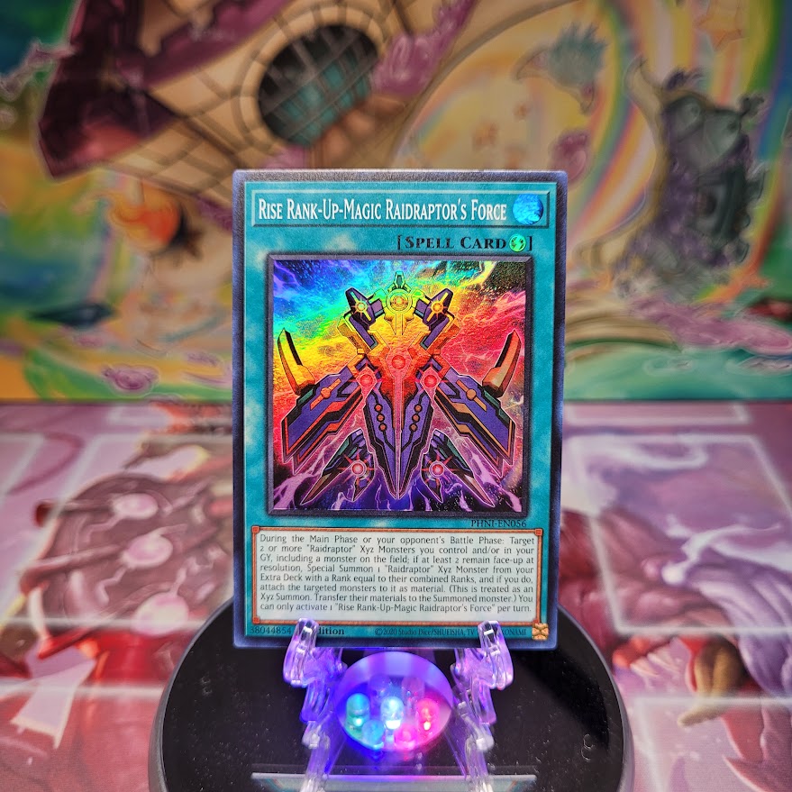 A Super Rare "Rise Rank-Up-Magic Raidraptor's Force" card from the Yugioh Set: Phantom Nightmare.