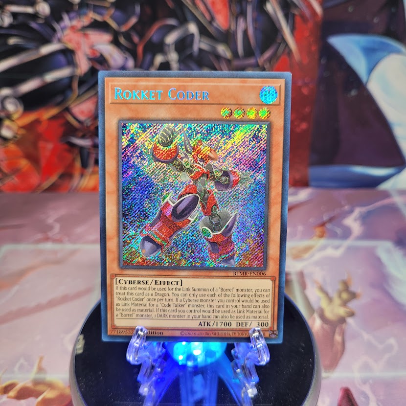 A Secret Rare "Rokket Coder" card from the Yugioh Set: Battles of Legend: Monstrous Revenge.