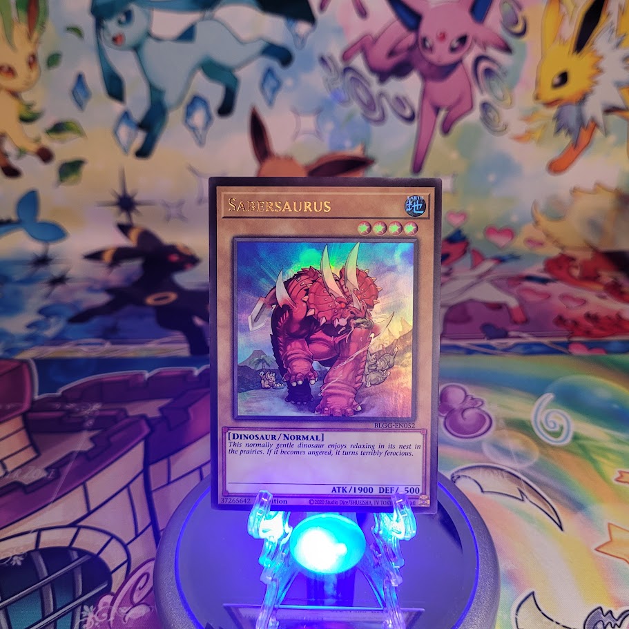 An Ultra Rare "Sabersaurus" card from the Yugioh Set: Battles of Legend: Glorious Gallery (BLGG).
