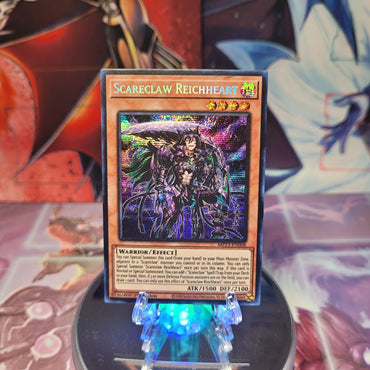 A Prismatic Secret Rare "Scareclaw Reichheart" card from the 25th Anniversary Dueling Heroes Mega-Tin Mega Pack.