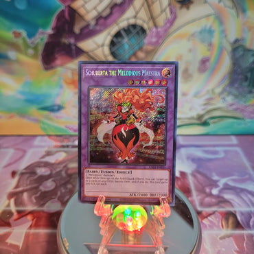  A Secret Rare "Schuberta the Melodious Maestra" card from the Yugioh Set: Quarter Century Bonanza (RA03).