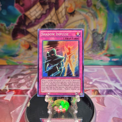 A Super Rare "Shadow Impulse" card from the Yugioh Set: Dragons of Legend.