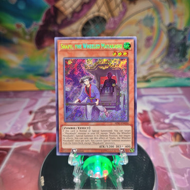 A 1st Edition Secret Rare "Shafu, the Wheeled Mayakashi" card from the Yugioh Set: Hidden Summoners.