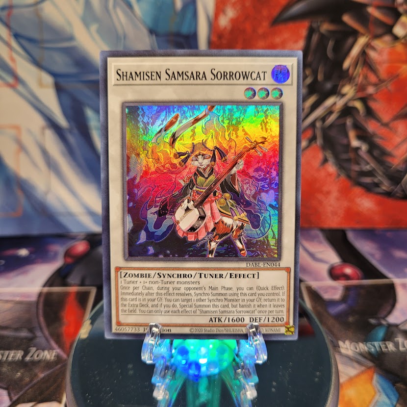 A Super Rare "Shamisen Samsara Sorrowcat" card from the Yugioh Set: Darkwing Blast.