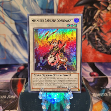 A Super Rare "Shamisen Samsara Sorrowcat" card from the Yugioh Set: Darkwing Blast.