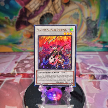 An Ultra Rare "Shamisen Samsara Sorrowcat" card from the Yugioh 25th Anniversary Dueling Heroes Mega-Tin Mega Pack.