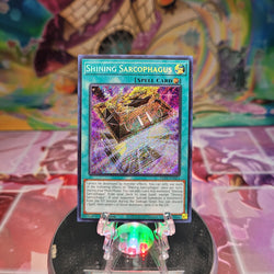 A 1st edition Secret Rare "Shining Sarcophagus" card from the Yugioh Set: Legacy of Destruction.