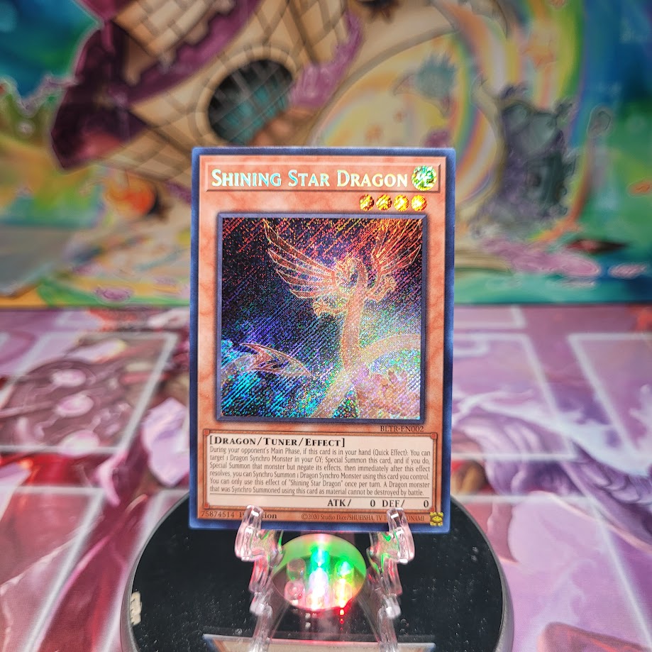 A Secret Rare "Shining Star Dragon" card from the Yugioh Set: Battles of Legend: Terminal Revenge (BLTR).