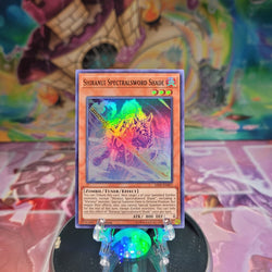 A Super Rare "Shiranui Spectralsword Shade" card from the Yugioh Set: Savage Strike.