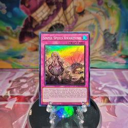 A Super Rare "Sinful Spoils Awakening" card from the Yugioh Set: Supreme Darkness (SUDA).