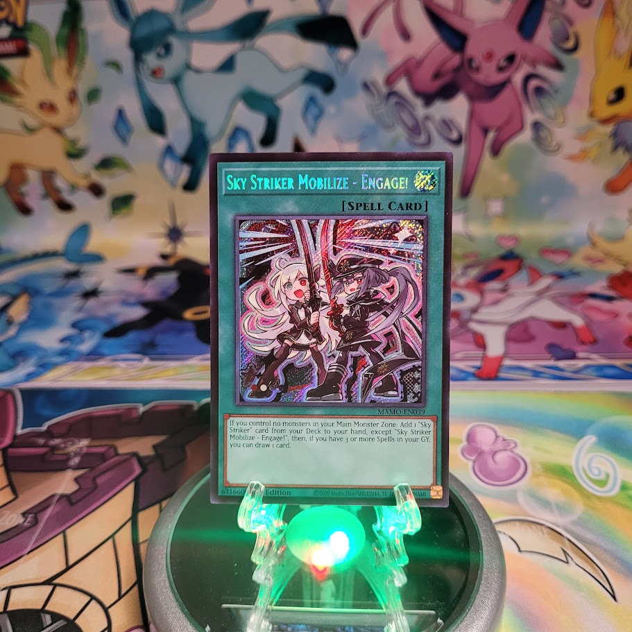 A Secret Rare "Sky Striker Mobilize - Engage!" card from the Yugioh Set: Magnificent Monsters (MAMO).