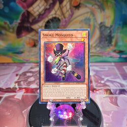 A Super Rare "Smoke Mosquito" card from the Yugioh Set: 25th Anniversary Tin: Dueling Heroes Mega-Tin Mega Pack.