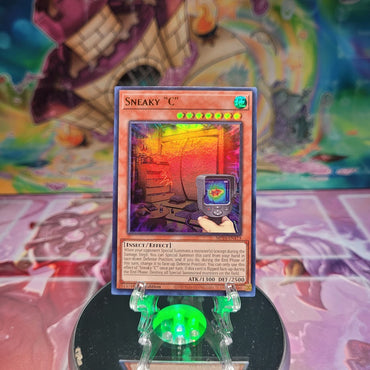 An Ultra Rare "Sneaky "C"" card from the Yugioh Set: 25th Anniversary Tin: Dueling Mirrors.