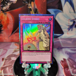 A Collector's Rare "Solemn Strike" card from the Yugioh Set: The Grand Creators (GRCR).