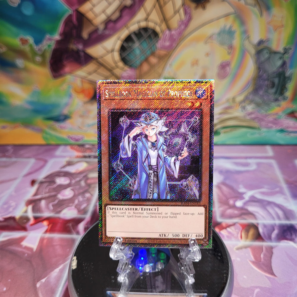 A Platinum Secret Rare "Spellbook Magician of Prophecy" card from the Yugioh Set: Quarter Century Stampede (RA04).