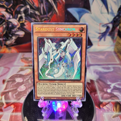A Secret Rare "Stardust Synchron" card from the Yugioh Set: Dawn of Majesty (DAMA).