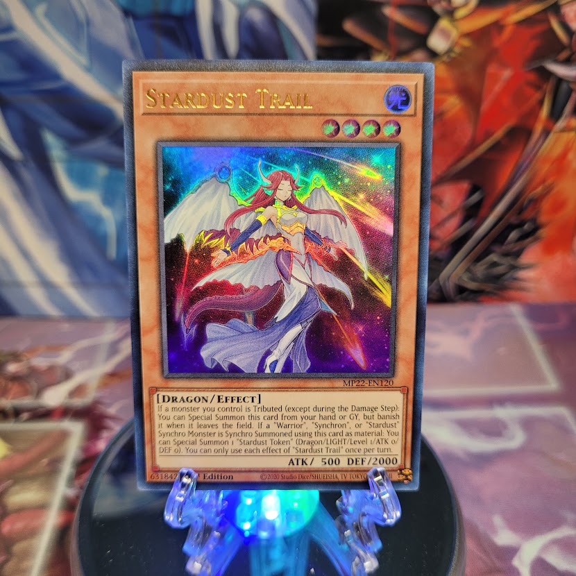 An Ultra Rare "Stardust Trail" card from the Yugioh 2022 Tin of the Pharaoh's Gods Set (MP22).